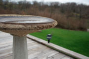 A shallow concrete birdbath